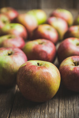 Fresh ripe apples on the wooden background. Selective focus. Shallow depth of field.