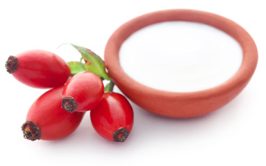 Rose hips with fresh milk in a pottery