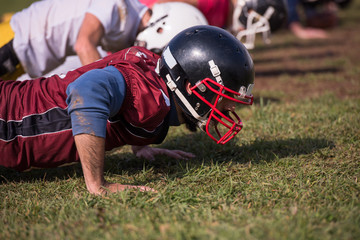 american football team doing push ups