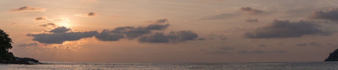 Naklejka na ściany i meble Large panorama of sunset on a coast.