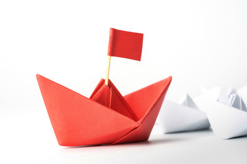 Leadership and Success concept with red paper ship.