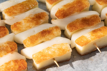 Roasted Cheese and Rice Cake (tteok in korea) grilled cheese stick at street food ,korean Street Food