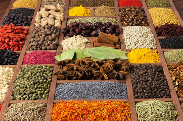 Different spice background. Condiments and herbs for the design of food packaging. Colorful seasoning in wooden boxes.