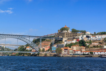 Fototapeta na wymiar Famous view of Porto and Vila Nova de Gaia, Portugal. Dom Luis I Bridge over the river Douro.