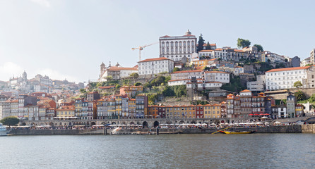 Fototapeta na wymiar Panoramic view of the Ribera, Porto, Portugal. Colorful houses on the embankment of the river Douro.