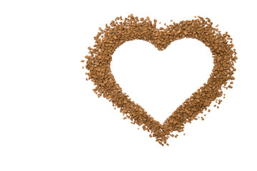 Dry instant coffee granules in the shape of a heart - brown texture