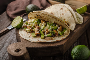 Homemade chicken thigh grilled, fresh avocado in tortilla