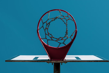 Basketball board under blue sky. Bottom view. Vintage style photo