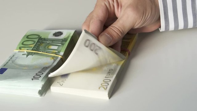 spreads the banknotes like a fan in nominal 200 and 100. euro money bundle of money &euro;