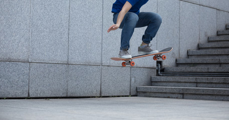Skateboarder doing ollie at city