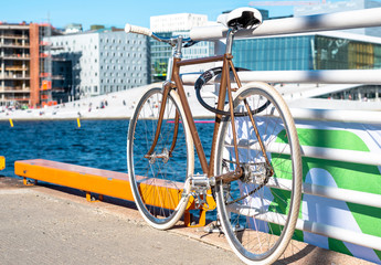 Beautiful, retro style bicycle parked on the street. White wheels, White Bicycle saddle, vintage style. Oslo, Norway