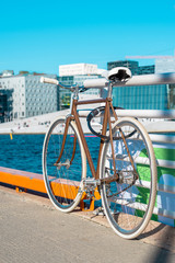 Beautiful, retro style bicycle parked on the street. White wheels, White Bicycle saddle, vintage style. Oslo, Norway