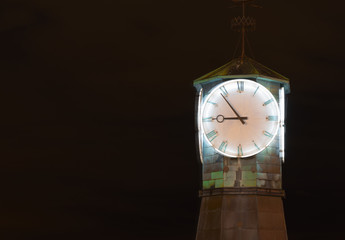 Vintage, Antique clock on the street against the dark sky. Clock face. Oslo, Norway