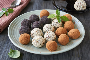 Homemade candies with dried fruits and nuts on a plate   