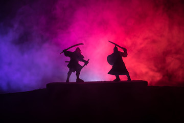 Silhouette of two samurais in duel. Picture with two samurais and sunset sky