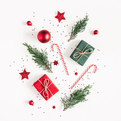Christmas composition. Gifts, fir tree branches, red decorations on white background. Christmas,...