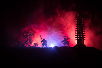 Samurai fighting concept. Silhouette of samurais in duel near tree and old temple. Picture with two...