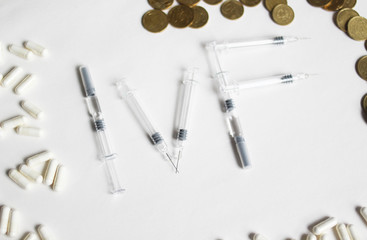 In Vitro Fertilization injection pen. IVF treatment drugs,  needles and pills. Stims and pio shots. Medication for infertility treatment on white background.  spelled with syringes. 