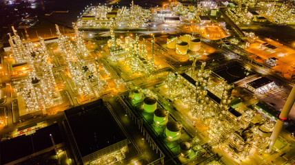 Oil storage tank with oil refinery background, Oil refinery plant at night.Aerial view from drone top view