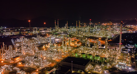 Oil storage tank with oil refinery background, Oil refinery plant at night.Aerial view from drone top view