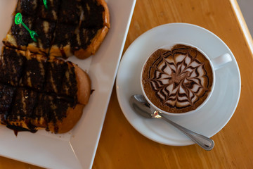 Coffee in a cup and bread with chocolate
