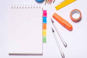 Page markers with stationary on office desk, top view