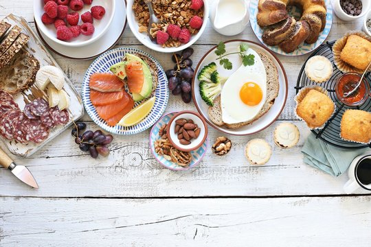 Brunch. Family breakfast or brunch set served on rustic wooden table. Overhead view, copy space