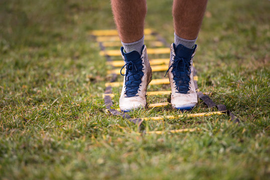 American Football Player Exercises On Ladder Drills