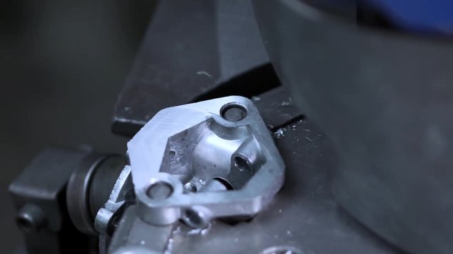 An Iron Round Part Rotates On The Machine