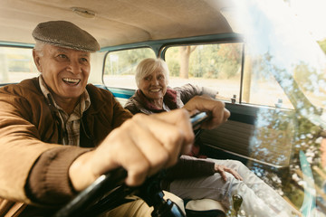 Happy senior couple going on a road trip