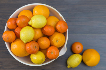 fruit bowl with different citrus fruits, oranges, tangerines and lemons