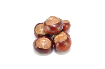Ripe chestnuts on white background close-up 
