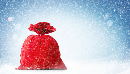 Santa Claus red bag full, on blue background with snow. 