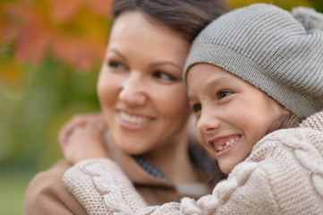 Portrait of a mother and daughter hugging outdoors