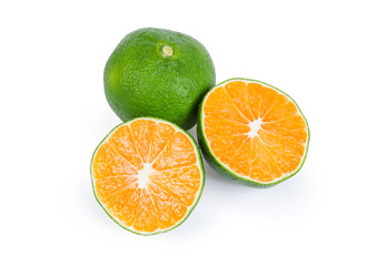 Two halves and whole ripe green tangerine on white background