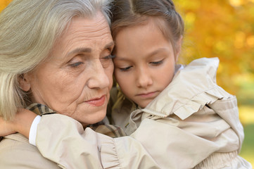 Portrait of a grandmother and granddaughter outdoors