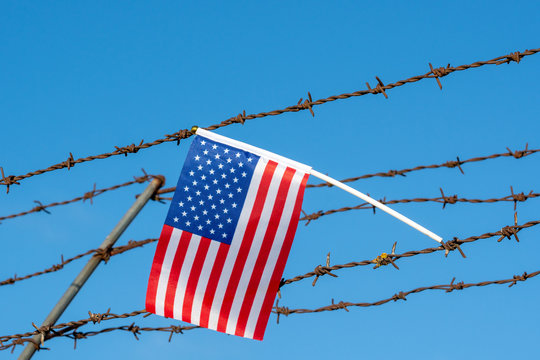 American flag on barbed wire fence