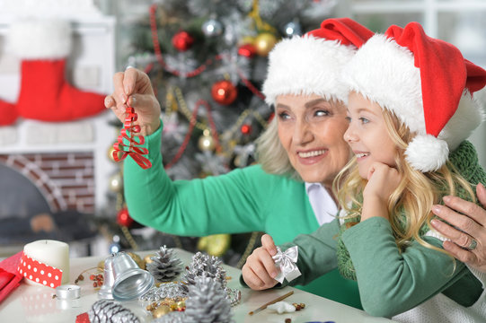 Portrait of girl with grandmother preparing for Christmas