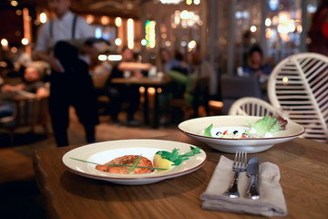 dinner at a restaurant grilled salmon / concept of a Mediterranean diet, seafood grilled and vegetables