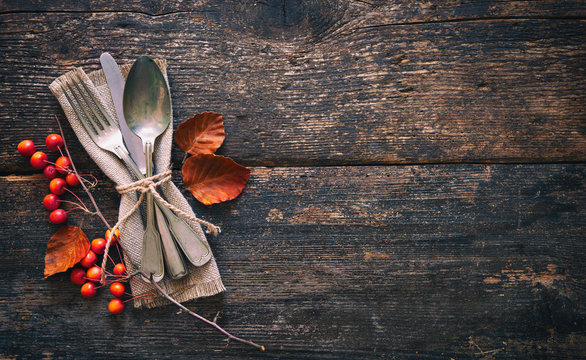 Autumn background with vintage place setting on old wooden table