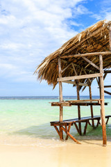 Beach hut with palm roof on the beach. Paradise Island, Dominican Republic.