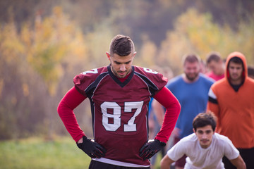american football players stretching and warming up