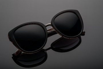 sunglasses on a dark background with reflection
