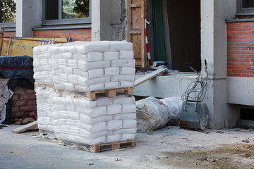 bags of cement in house under construction
