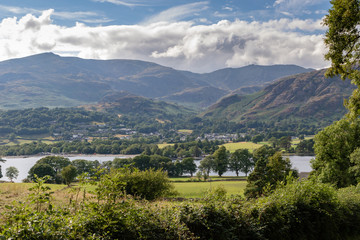 Fototapeta na wymiar Lake Coniston Water and Coniston village in background in the Lake District National Park, UK