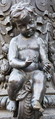 Fototapeta na wymiar beautiful bronze angel sitting