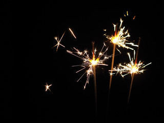 Fototapeta premium Christmas sparklers in the dark, background for xmas, new year