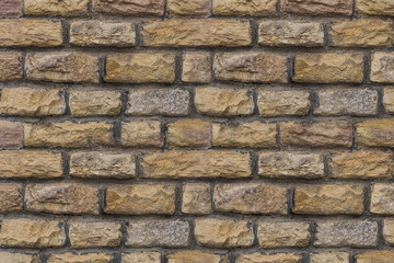beige stone chipped uneven weathered hard background base of many rectangular blocks