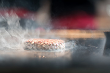 Cutlets from minced meat roasted on the grill. Meat hamburger Patty closeup. Ingredients for Burger. cooking barbecue outside. process of preparation of ingredients for a Burger
