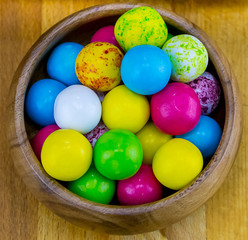 Fototapeta na wymiar colorful various round candy yellow blue bright dessert in a wooden bowl close-up
